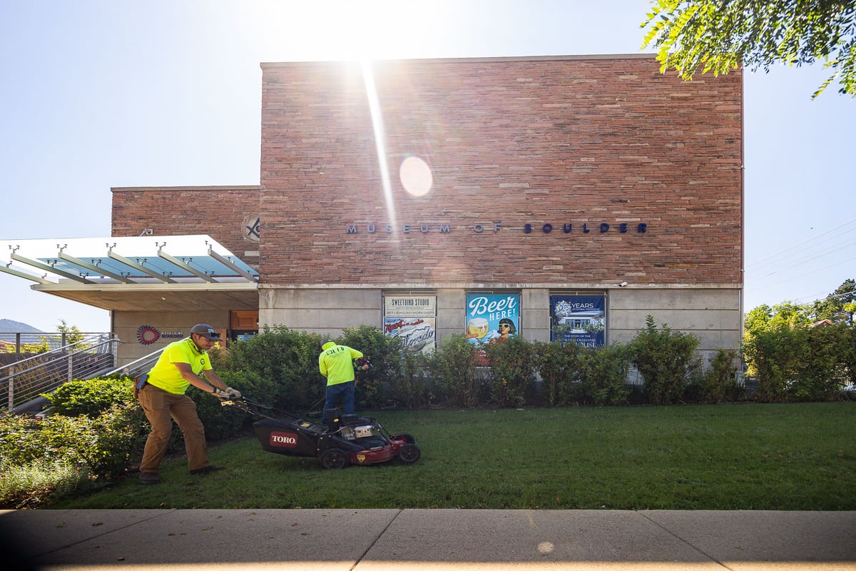 Commercial property maintenance crew mowing and trimming