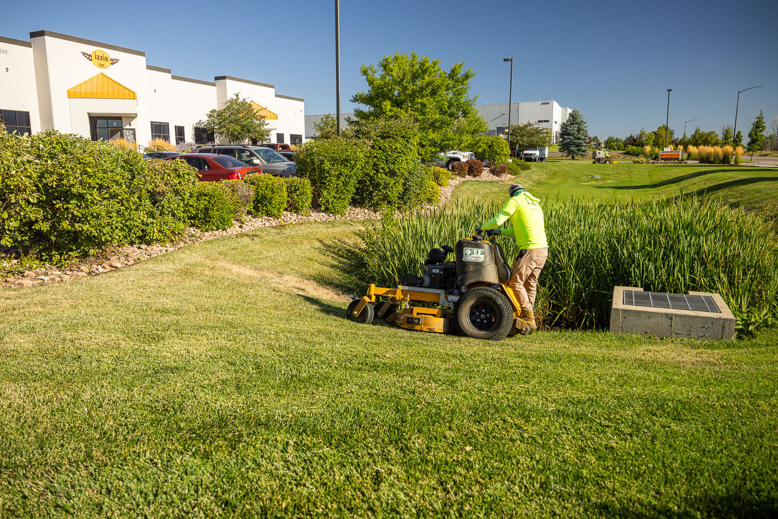 commercial property landscape maintenance crew mowing 3