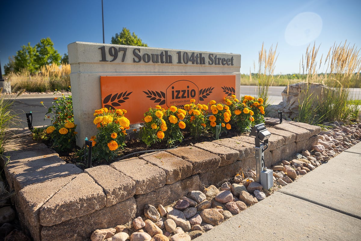 commercial property landscape maintenance sign with flowers