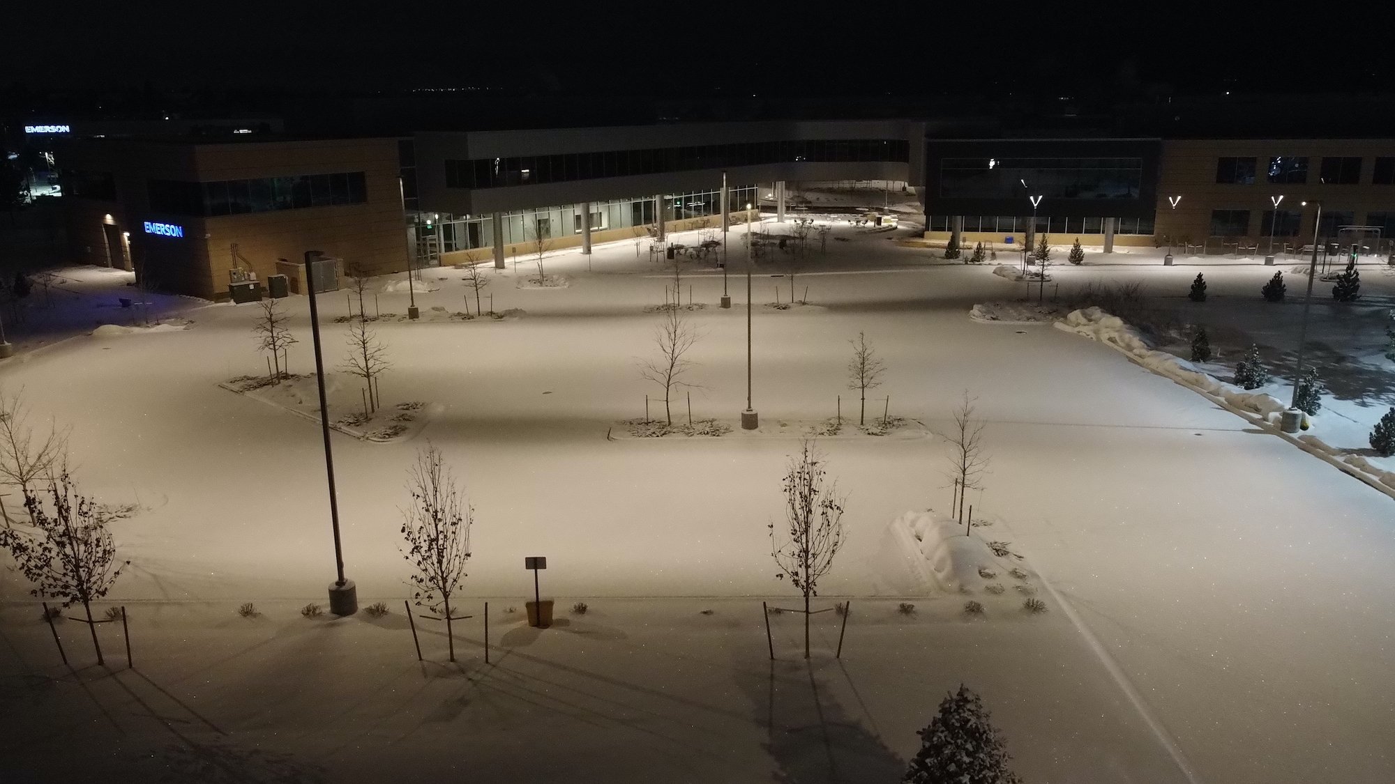 Parking lot full of snow at night commercial business