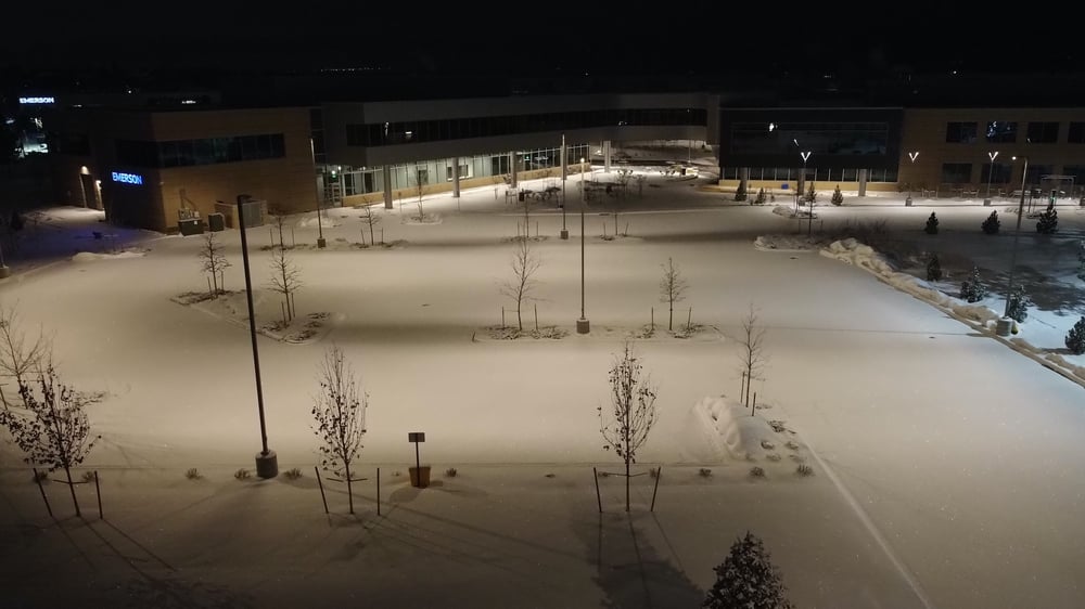 Parking lot full of snow at night commercial business