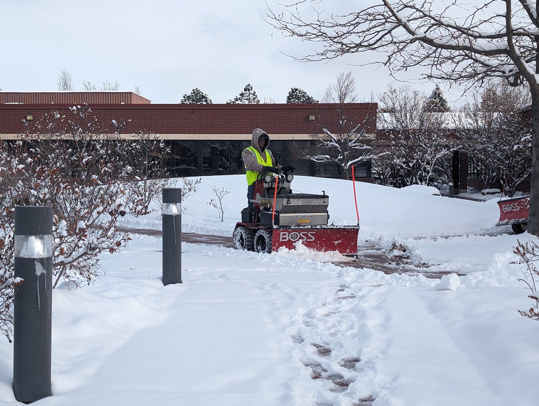 crew snow blowing sidewalks commercial property