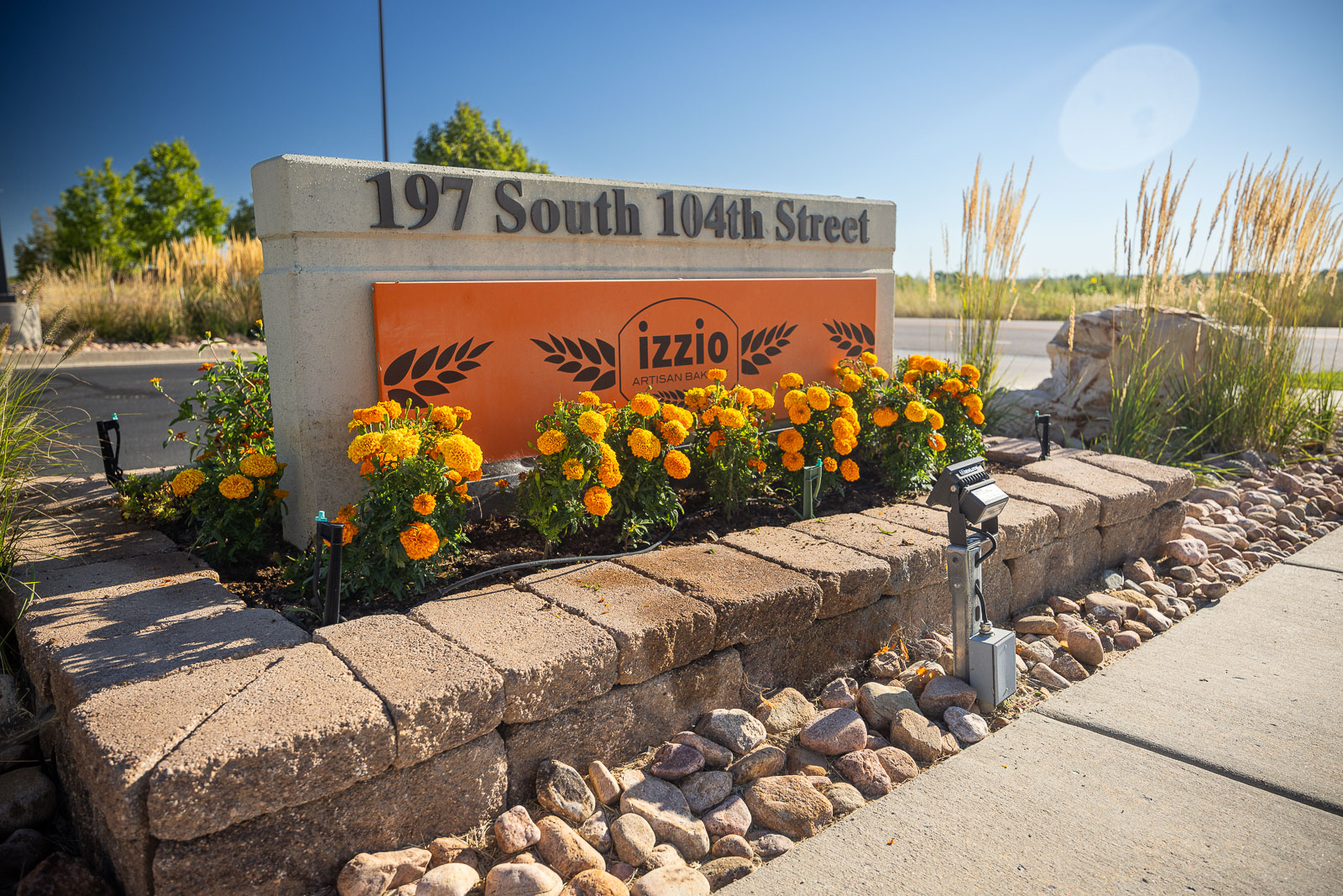 commercial sign with flowers planted 