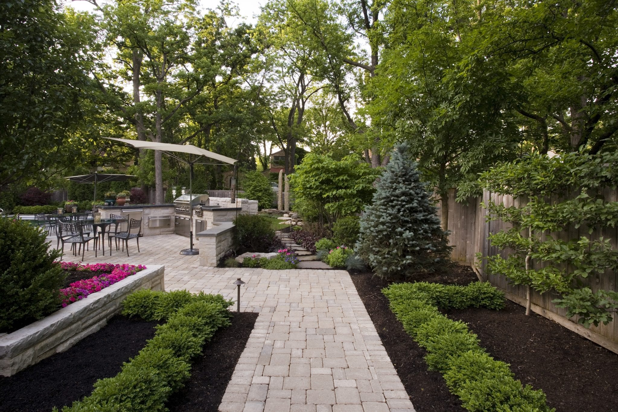 backyard irregular brick path leading to outdoor kitchen